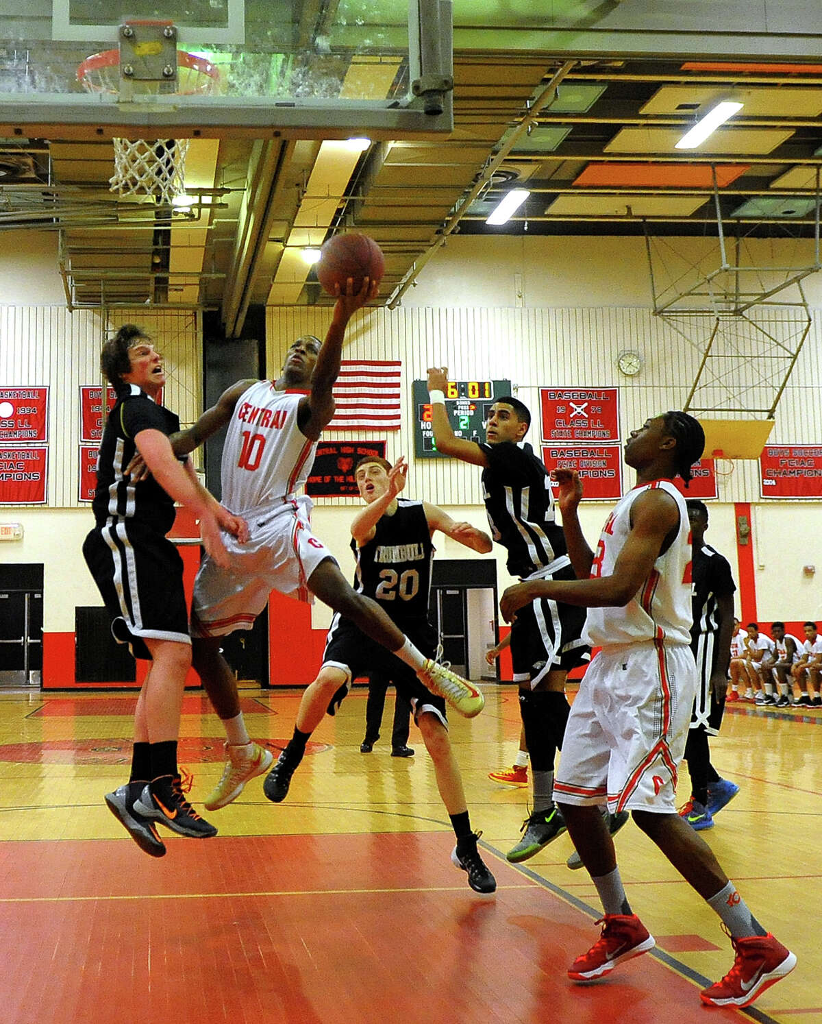 Central's Sha'quan Bretoux takes a shot up to the basket, during boys basketball action against Trumbull in Bridgeport, Conn. on Friday February 7, 2014. Defending at left is Trumbull's Ben McCullough.