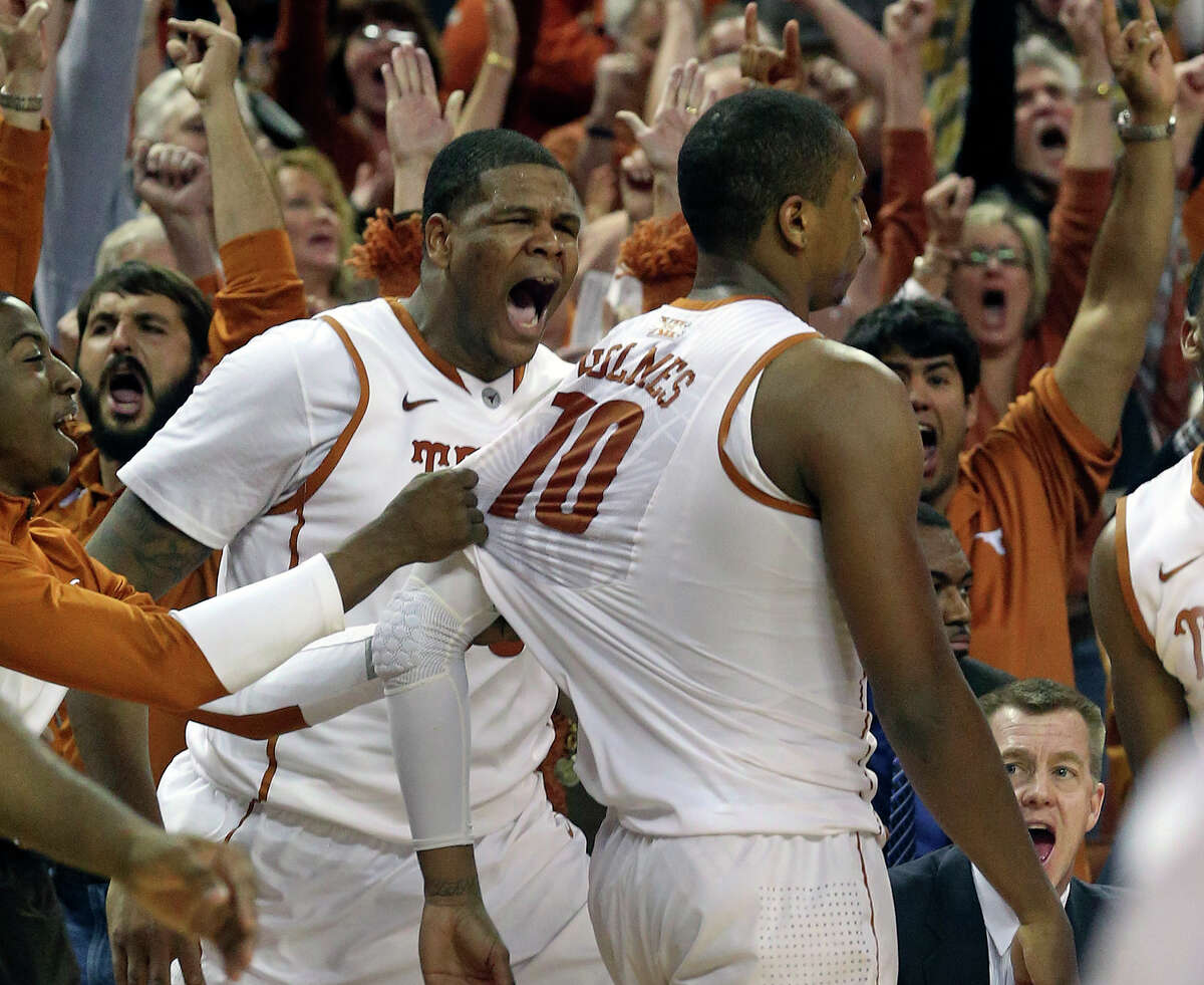 Longhorn center Cameron Ridley screams along with fans as Johnathan Holmes turns and walks off the court after hitting a buzzer beating three pointer to give his team a 67-64 win as UT hosts Kansas State at the Erwin Center in Austin on January 21, 2014.