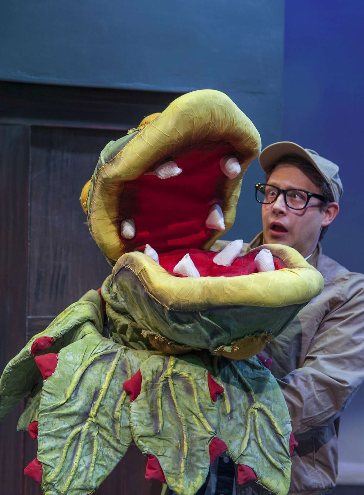 Audrey II and Seymour (Adam Cotugno) in Foothill Music Theatre's "Little Shop of Horrors"