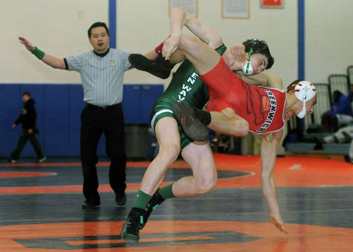 New Milford's Kyle Lindner takes down Greenwich's Alex Margetoes in the 113-pound division of the wrestling match between between New Milford and Greenwich as part of the meet between Danbury, New Milford, Greenwich, Darien, Xavier and Harding at Danbury High School in Danbury, Conn. on Saturday, Feb. 8, 2014.