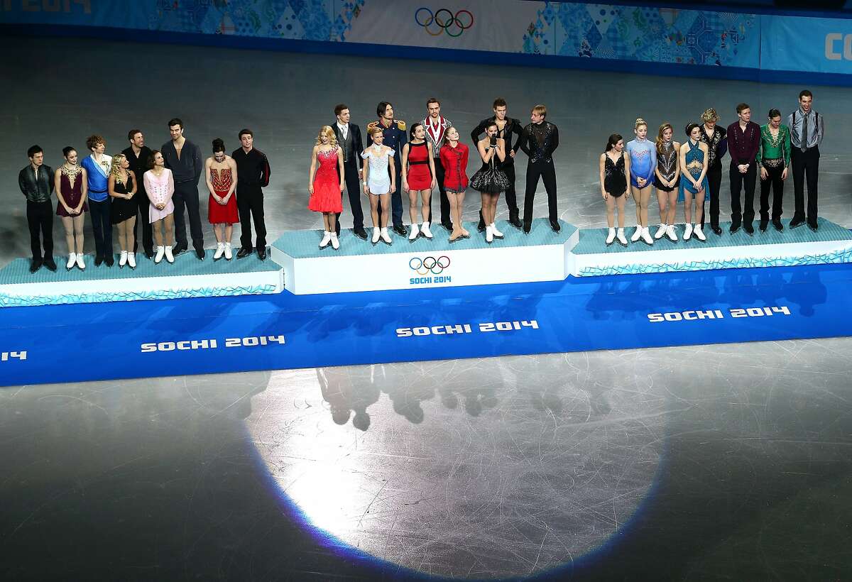 (L-R) Silver medalists team Canada, gold medalists team Russia and bronze medalists team USA pose on the podium during the flower ceremony for the Team Figure Skating Overall during day two of the Sochi 2014 Winter Olympics at Iceberg Skating Palace on February 9, 2014 in Sochi, Russia.