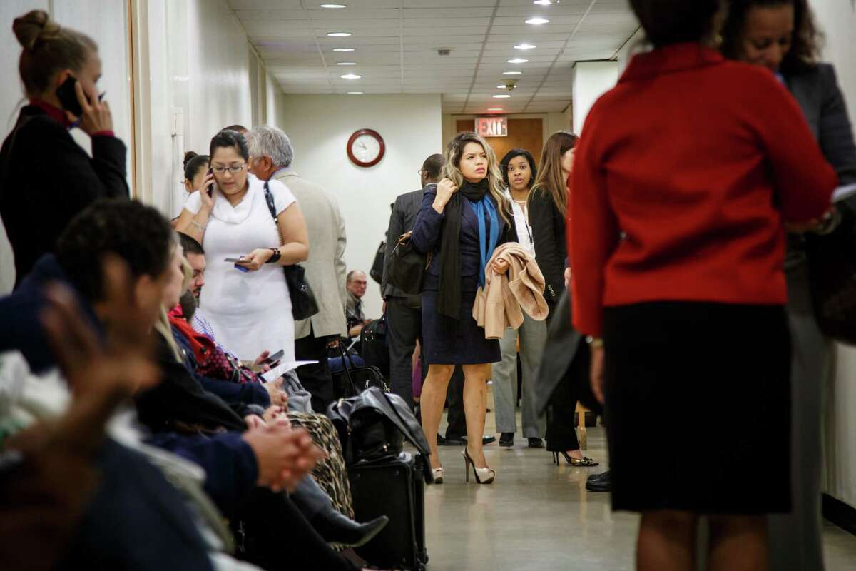People crowd the hallways of the seventh floor of the Family Law Center. A new, temporary court seeks to expedite cases and ease the backlog that hurts children.