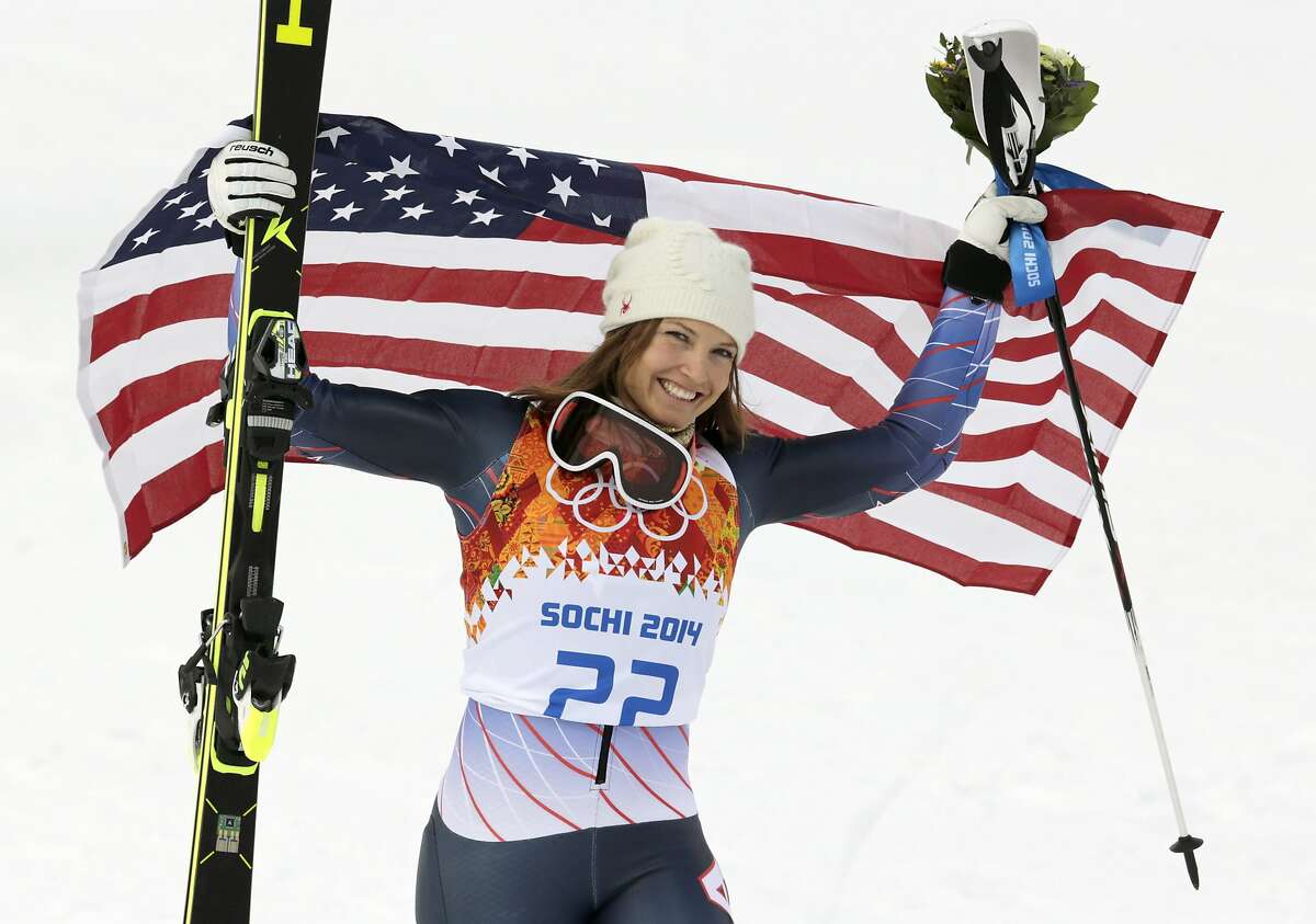 Women's supercombined bronze medalist United States' Julia Mancuso poses with the U.S. flag after a flower ceremony at the Alpine ski venue in the Sochi 2014 Winter Olympics, Monday, Feb. 10, 2014, in Krasnaya Polyana, Russia.