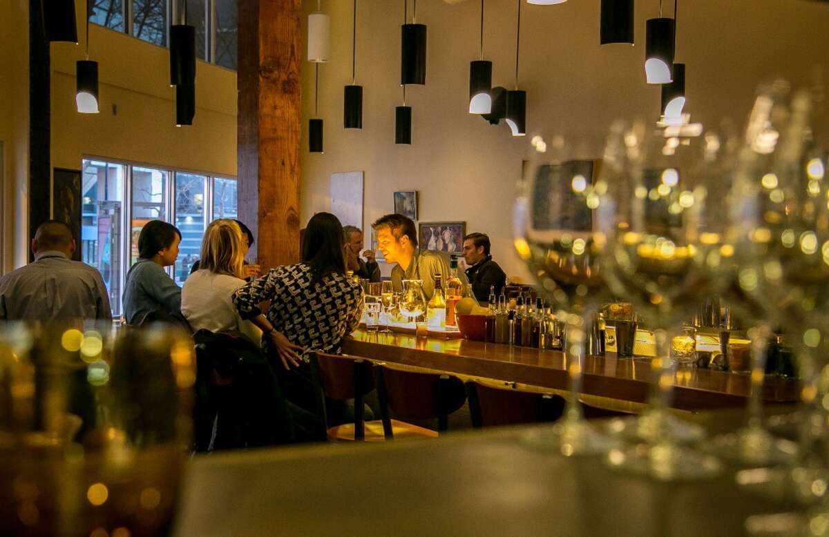 People enjoy dinner at the bar at Alta CA in San Francisco.