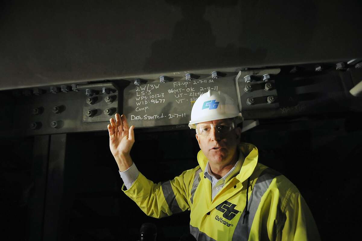 Chief Deputy Director of Caltrans Rick Land, points out where water is leaking from overhead into the hollow steel box girders that make up the roadway of the Eastern span of the Bay Bridge in Oakland, CA Monday, February 10, 2014.