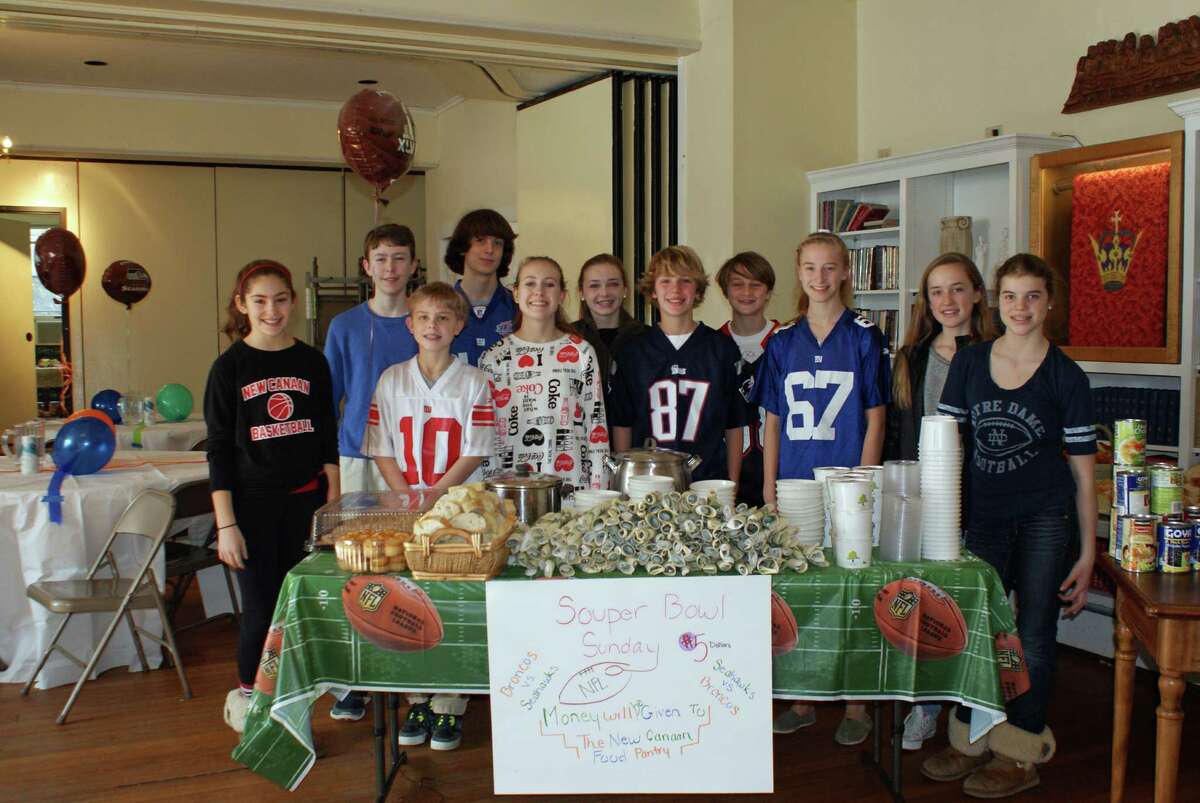 Members of the middle school youth group of First Presbyterian Church pause before the opening of their SouperBowl of Caring Café.