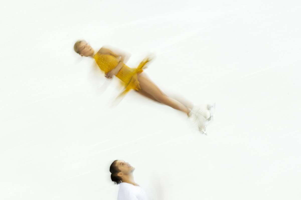 Tatiana Volosozhar and Maxim Trankov of Russia compete in the pairs free skate figure skating competition at the Iceberg Skating Palace during the 2014 Winter Olympics, Wednesday, Feb. 12, 2014, in Sochi, Russia.