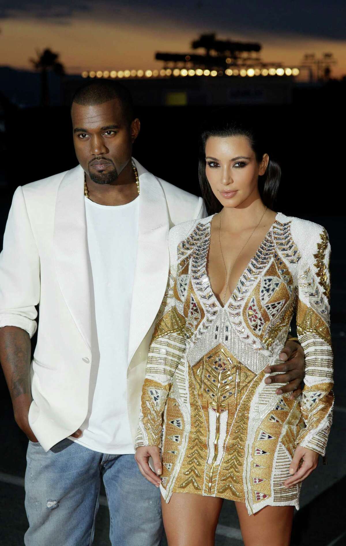 FILE - In this May 23, 2012 file photo, singer Kanye West, left, and television personality Kim Kardashian arrive for the screening of "Cruel Summer" at the 65th international film festival, in Cannes, southern France. Now that Beyonce and Jay-Z have confirmed that they're attending the BET Awards, on Sunday, July 1, 2012, the next question is: Will West be the third wheel, or will his girlfriend Kardashian be on his arm? (AP Photo/Francois Mori, File)