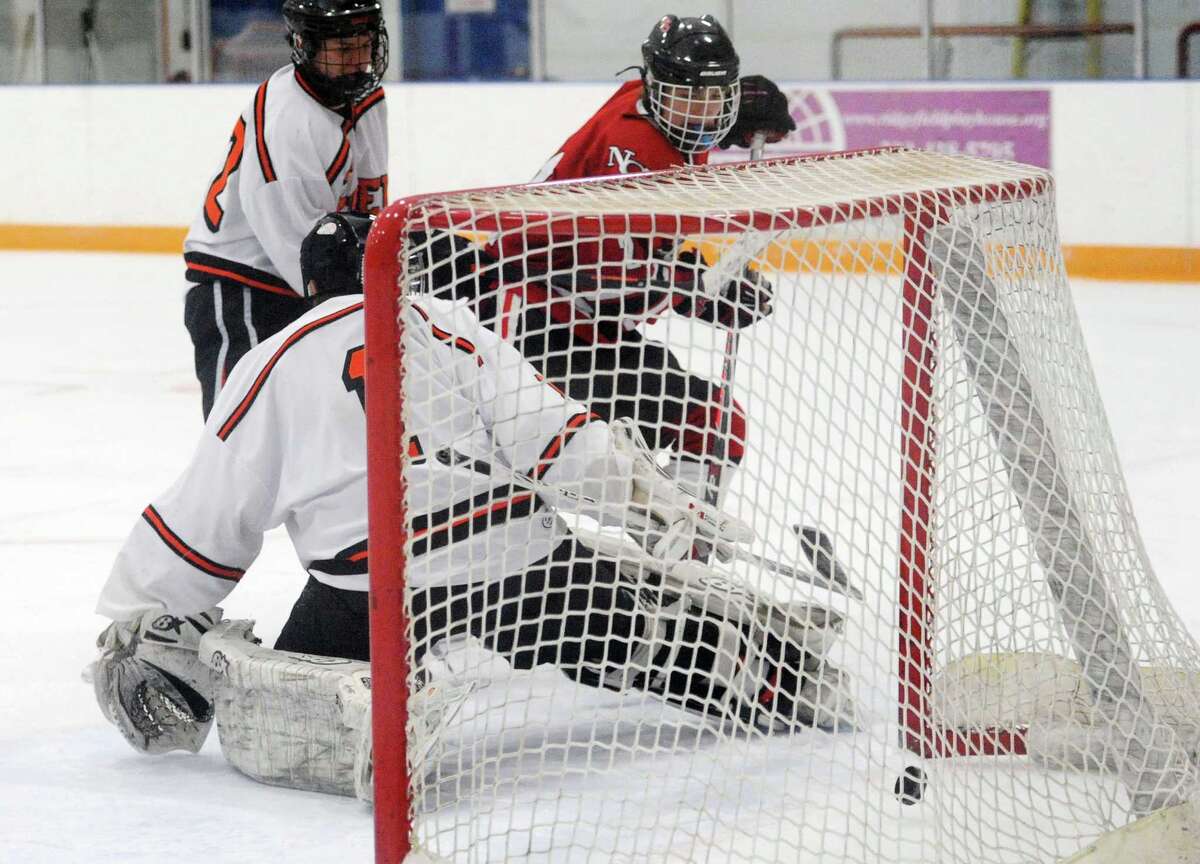 Ridgefield holds off New Canaan in hockey battle