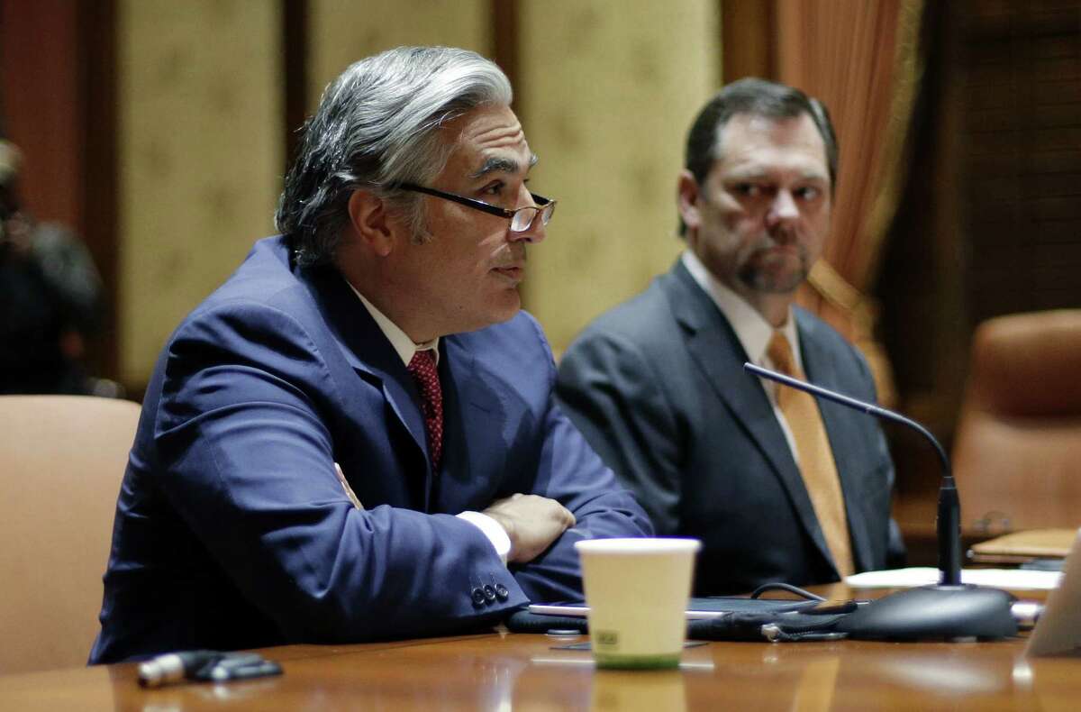 UT System Chancellor Francisco Cigarroa (left) listens to a question during the news conference in which he announced his resignation.