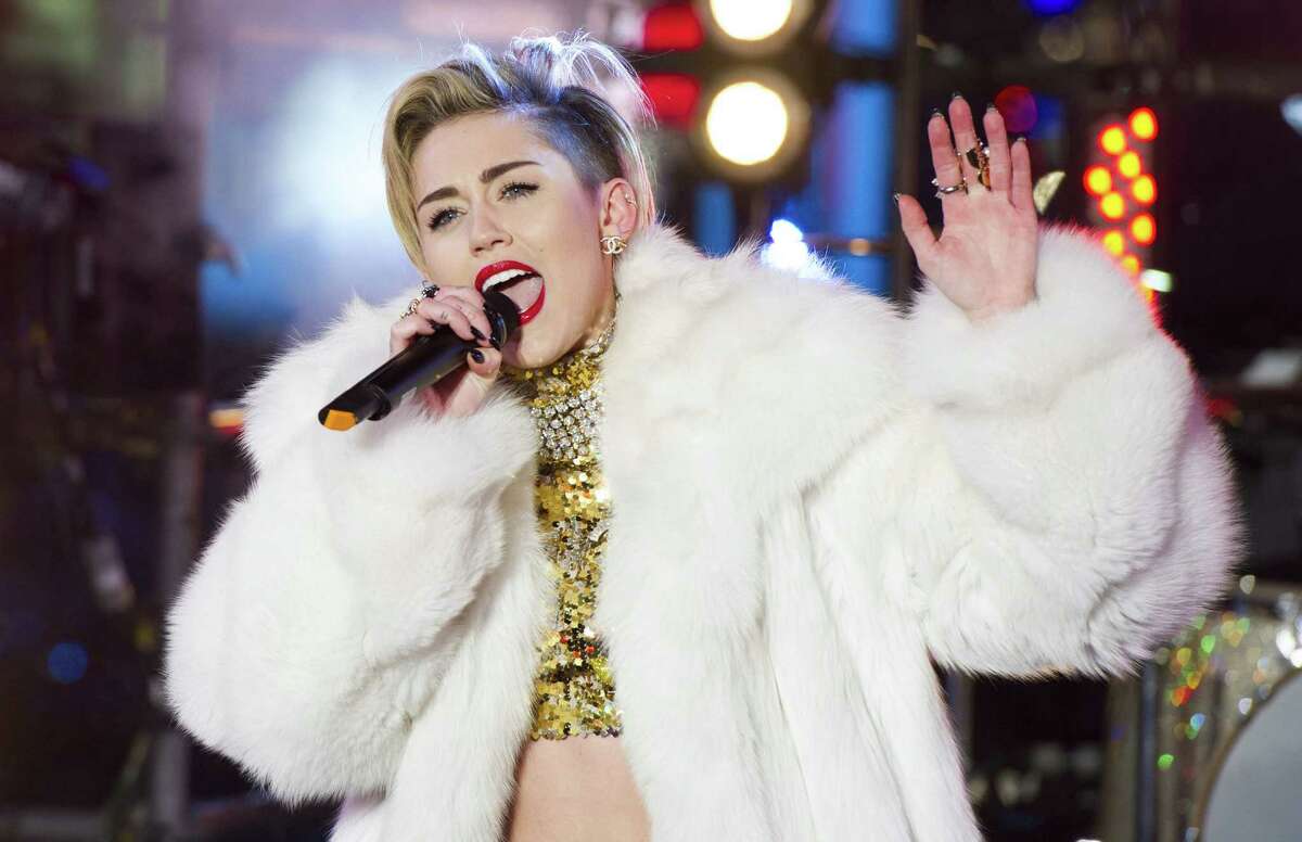 In this Dec. 31, 2013 file photo, Miley Cyrus performs in Times Square during New Year's Eve celebrations in New York. Cyrus is kicking off her North American Ã´BangerzÃ¶ tour Feb. 14, 2014, in Vancouver. Ã´Ren and StimpyÃ¶ creator John Kricfalusi and LA contemporary artist Ben Jones have crafted videos to play during the 38 shows as Cyrus prioritizes singing over dance routines. (Photo by Charles Sykes/Invision/AP, File)