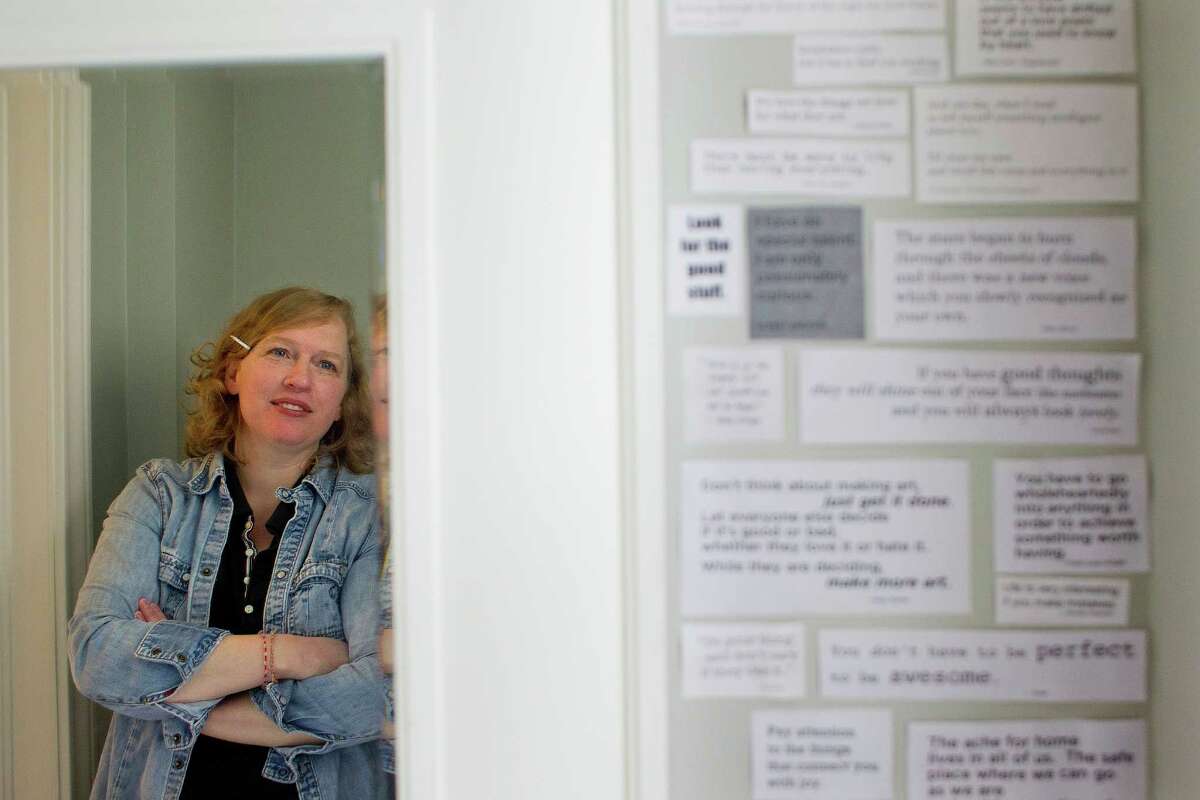 Local novelist Katherine Center has covered the walls of the bathroom she shares with her husband and two young children with quotes -- dozens and dozens of tiny pieces of paper, neatly taped to the walls, filled with happy, thoughtful, inspiring messages from books, movies, people, and her children Monday, Feb. 10, 2014, in Houston. ( Johnny Hanson / Houston Chronicle )