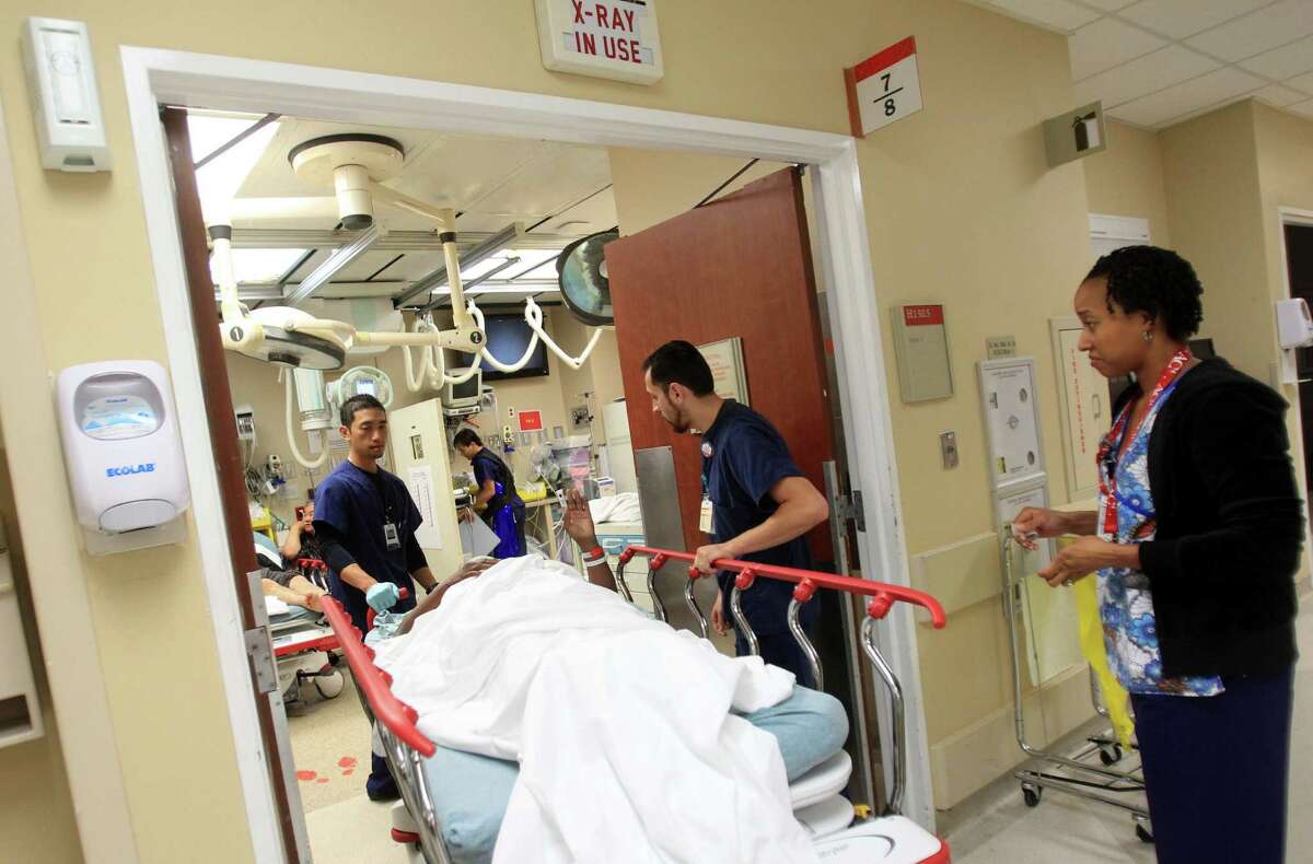 A patient is moved into the emergency room trauma center at Memorial Hermann-Texas Medical Center in Houston. The head of the Texas Hospital Association said medical facilities must team up on a long-term strategy to compensate for Medicaid shortfalls.