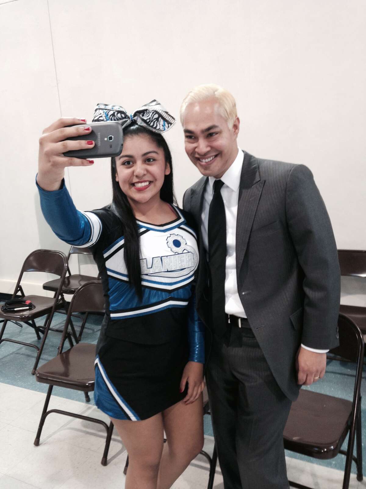 A Lanier High School Cheerleader snaps a selfie with San Antonio Mayor Julian Castro.