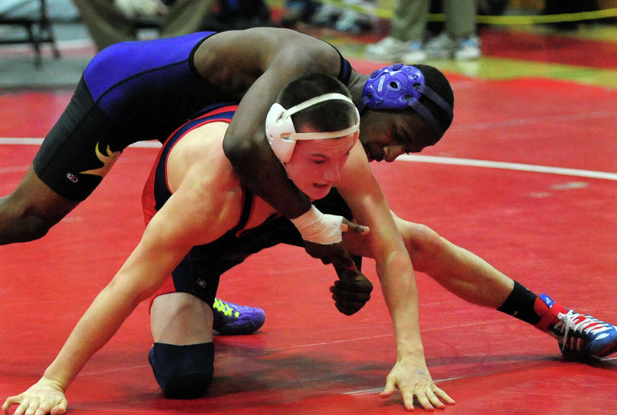 Westhill's Jeff Glover, top, wrestles McMahon's Sawyer Machette, during FCIAC Wrestling Championship action at New Canaan High School in New Canaan, Conn. on Saturday February 15, 2014.