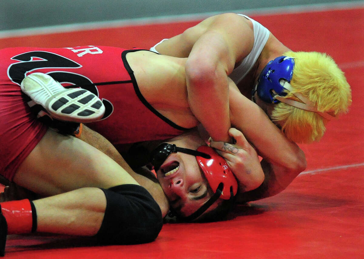 Danbury's Steven Beckham, top, wrestles against Fairfield Warde's Dylan Bender, during FCIAC Wrestling Championship action at New Canaan High School in New Canaan, Conn. on Saturday February 15, 2014.