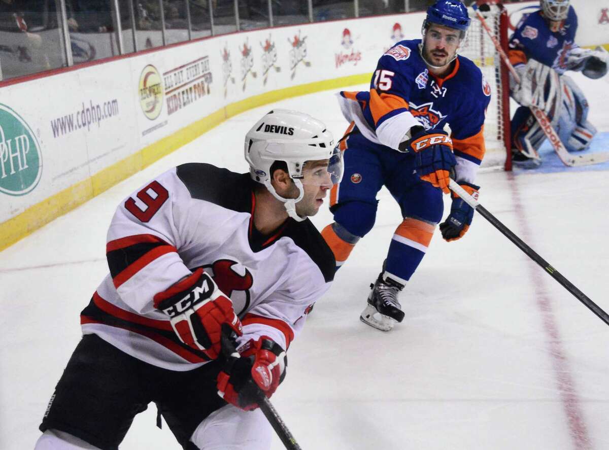 Albany Devils' #9 Joe Whitney, left, during Saturday's game against the Bridgeport Sound Tigers at the Times Union Center Nov. 30, 2013, in Albany, NY. (John Carl D'Annibale / Times Union)