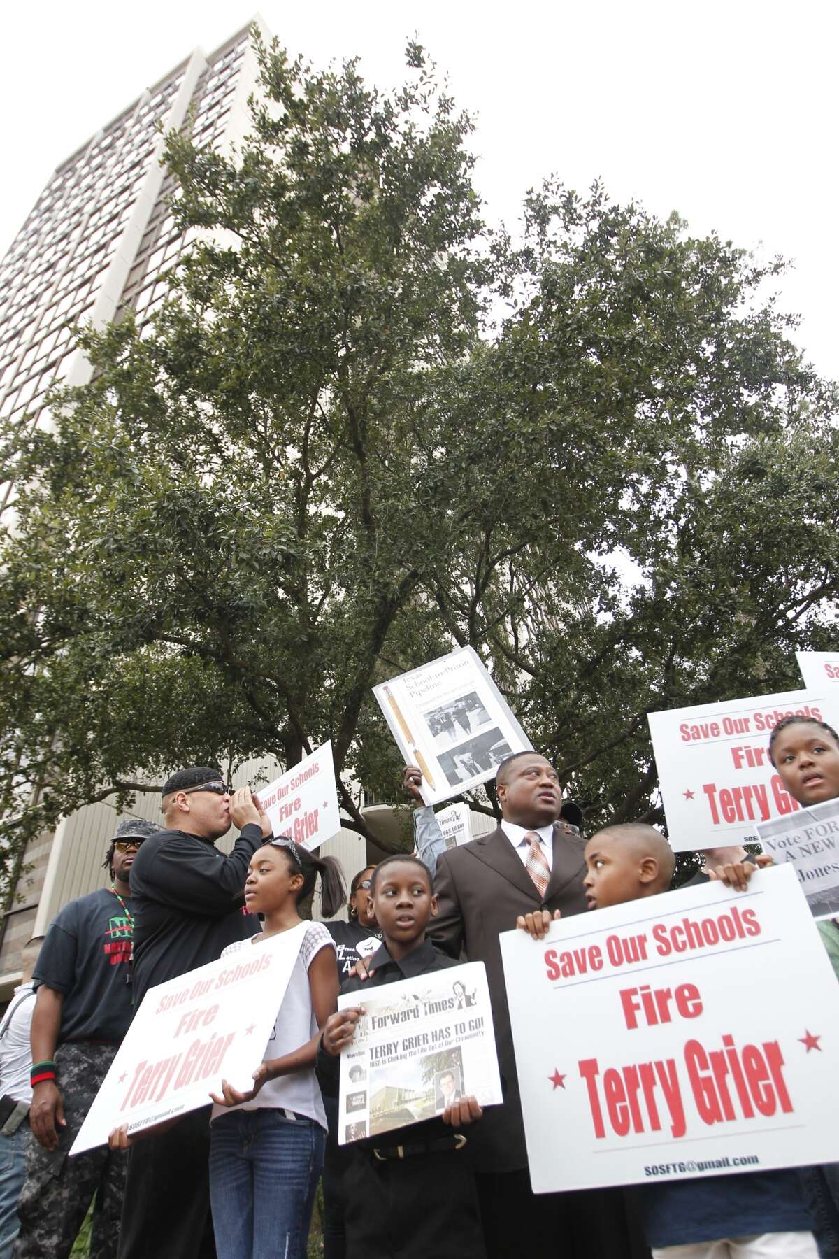 About two dozen leaders in the black community protested Sunday outside HISD Superintendent Terry Grier's home, calling for his firing for plans to close schools their neighborhoods. (Johnny Hanson / Houston Chronicle)