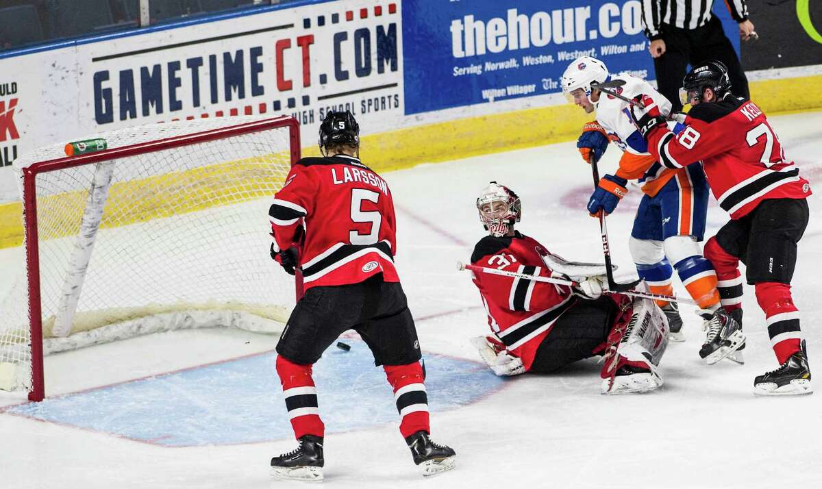 The Bridgeport Sound Tigers Andrew Clark watches as the puck gets by Albany Devils goalie Scott Wedgewood during a ice hockey game played at the Webster Bank arena, Bridgeport, CT on Sunday, February, 16th, 2014.