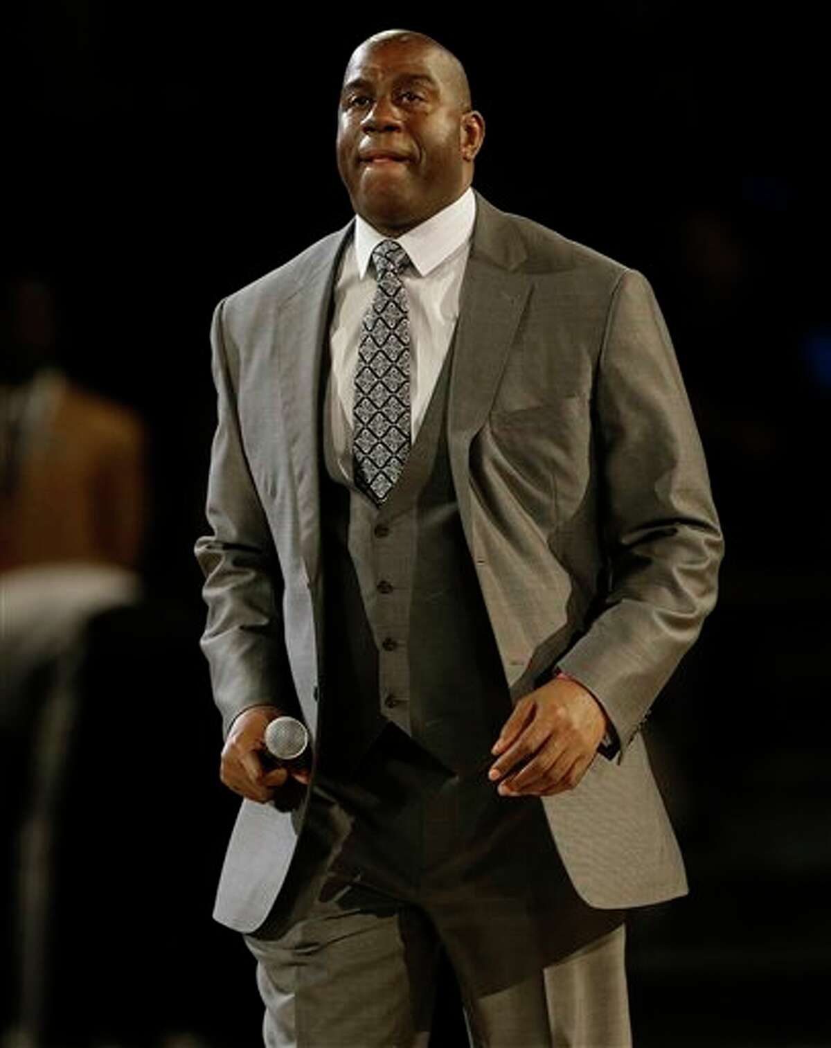Former NBA player Earvin "Magic" Johnson, Jr. walks on the court during the NBA All Star basketball game, Sunday, Feb. 16, 2014, in New Orleans. (AP Photo/Gerald Herbert)