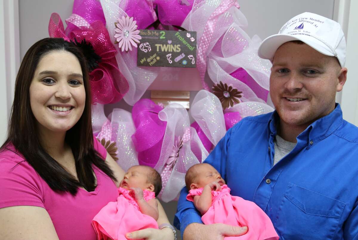 Samantha and Eric Kreger of Santa Fe hold twins Caylee, left, and Callie before leaving the hospital. The girls were the first babies born at the renamed Houston Methodist St. John Hospital. Photo courtesy of Houston Methodist.