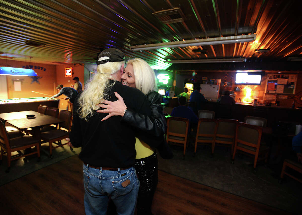 Melissa Lowe smiles as she dances with Phil Blackburn, owner of Phil's, on Wednesday night. Phil's, the bar formerly known as The Thirsty Rose, in Silsbee will be holding a grand reopening on March 15 in conjunction with a chili cook off. Photo taken Wednesday, 2/12/14 Jake Daniels/@JakeD_in_SETX