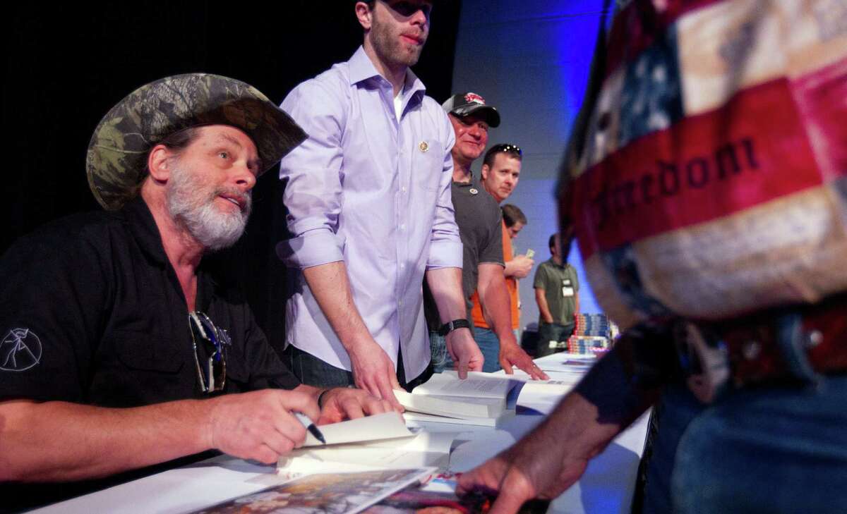 A vocal supporter of gun rights and the Second Amendment, Ted Nugent signs autographs at the National Rifle Association's May meeting in Houston.