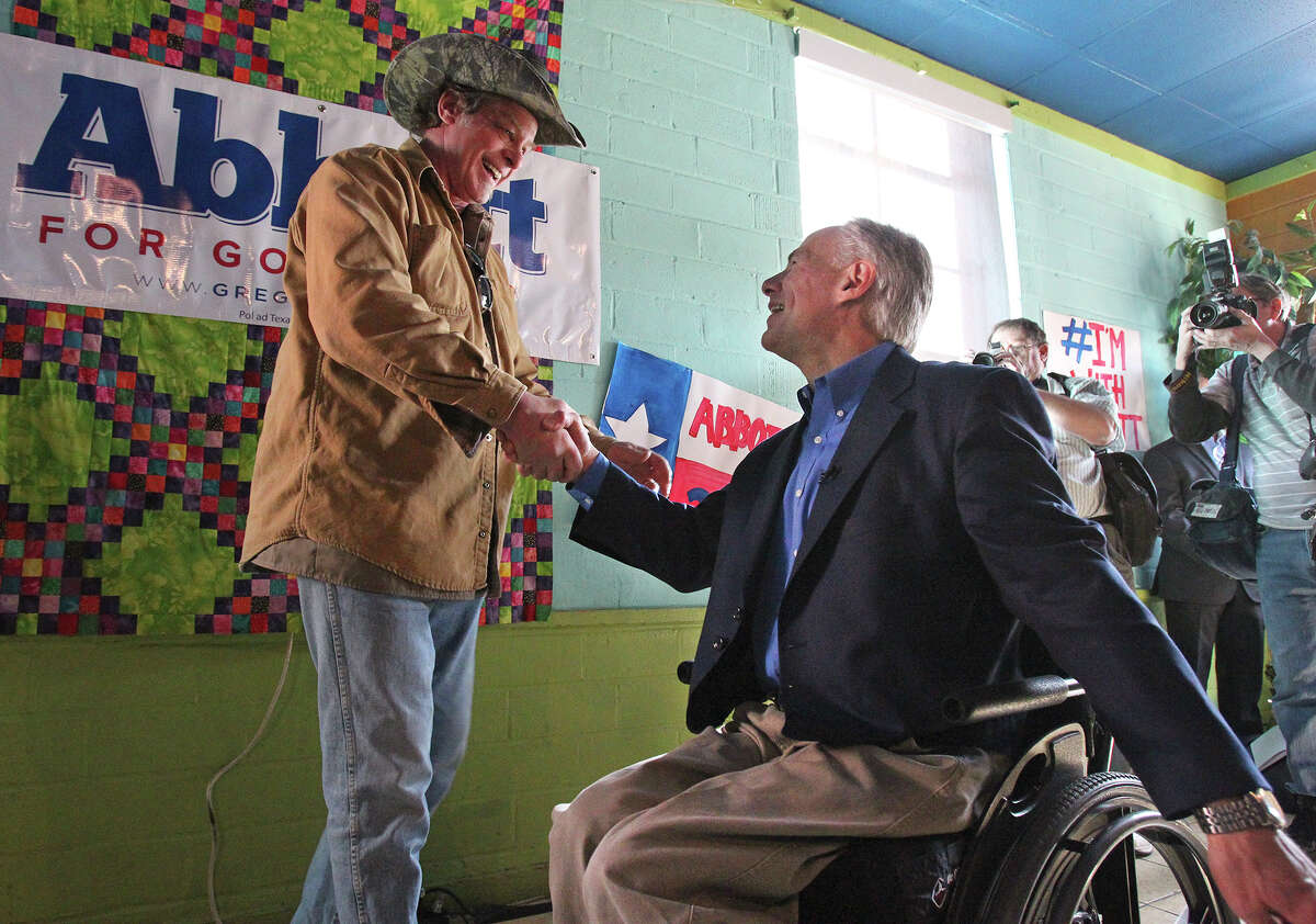 Ted Nugent shakes hands with the candidate as he speaks at a campaign event for Greg Abbott at El Guapo's restaurant in Denton on February 18, 2014.