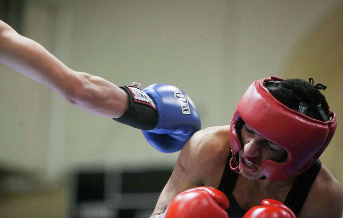 Jacob Macias of Champion Fit Gym tries to evade a punch from Angel Gongora of Elizando Boxing Club during the San Antonio Regional Golden Gloves at Woodlawn Gym. Gongora won.