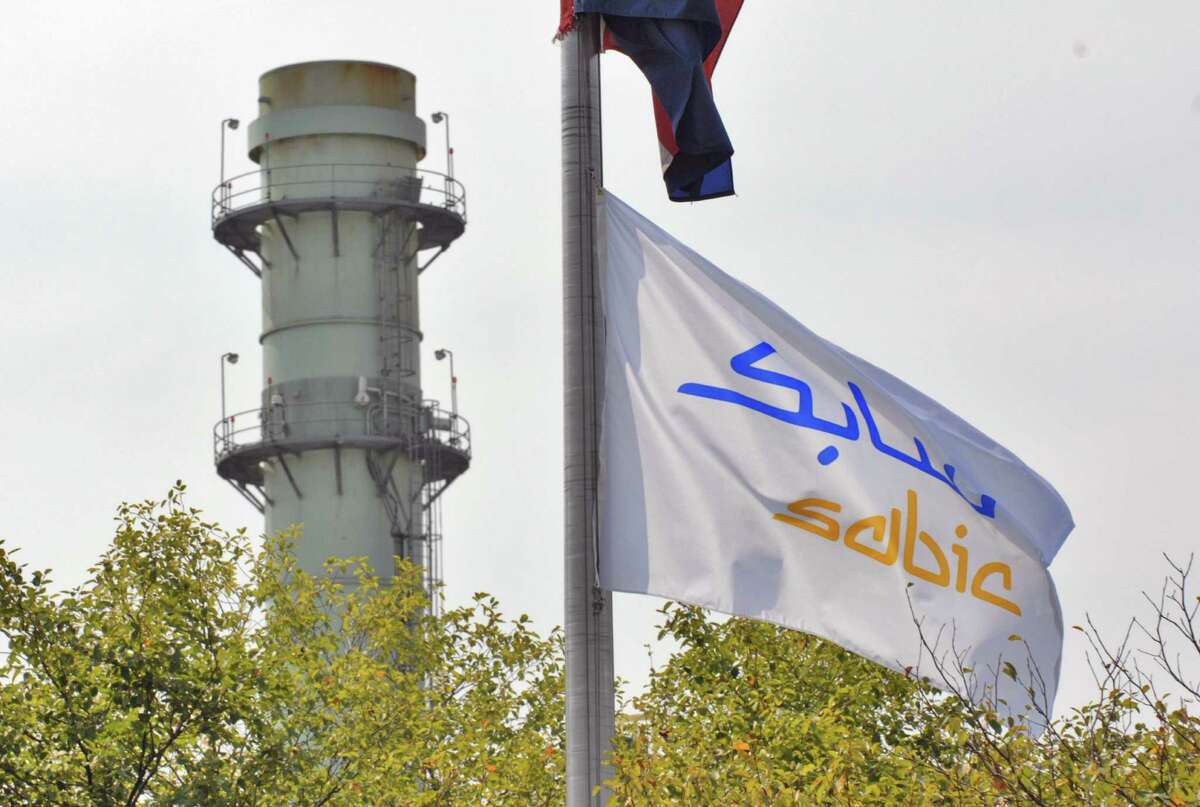 Times Union Staff photograph by Philip Kamrass -- A flag for SABIC Innovative Plastics hangs within sight of a tower from the plant's cogenerating facility, in Selkirk, NY Thursday September 6, 2007. The Saudi company purchased the plant from General Electric recently. FOR LARRY RULISON SUNDAY STORY.