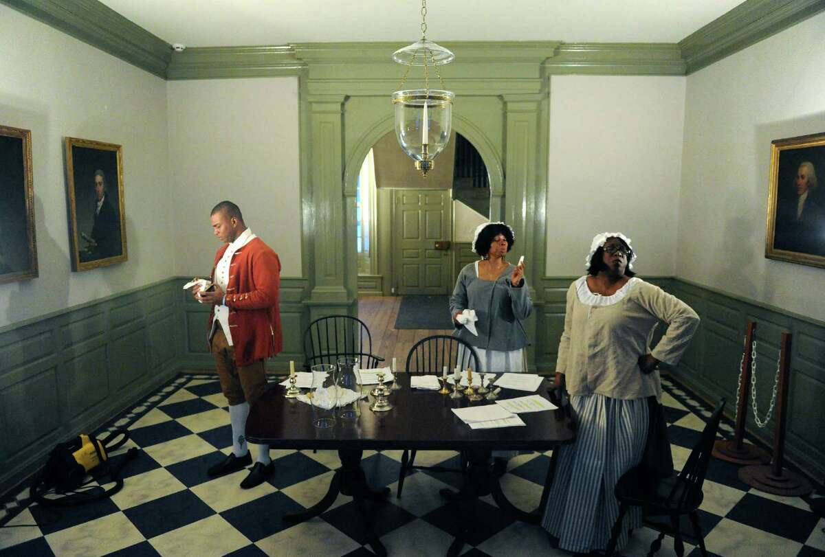 Actors Mike Banks, left, Regina Wright, center, and Shelah London rehearse for a play Wednesday Feb. 19, 2014, at Schuyler Mansion in Albany, N.Y. The play is based on a 1793 Albany fire in which 3 slaves were falsely accused and hanged. It will be performed Saturday at Schuyler Mansion. (Michael P. Farrell/Times Union)