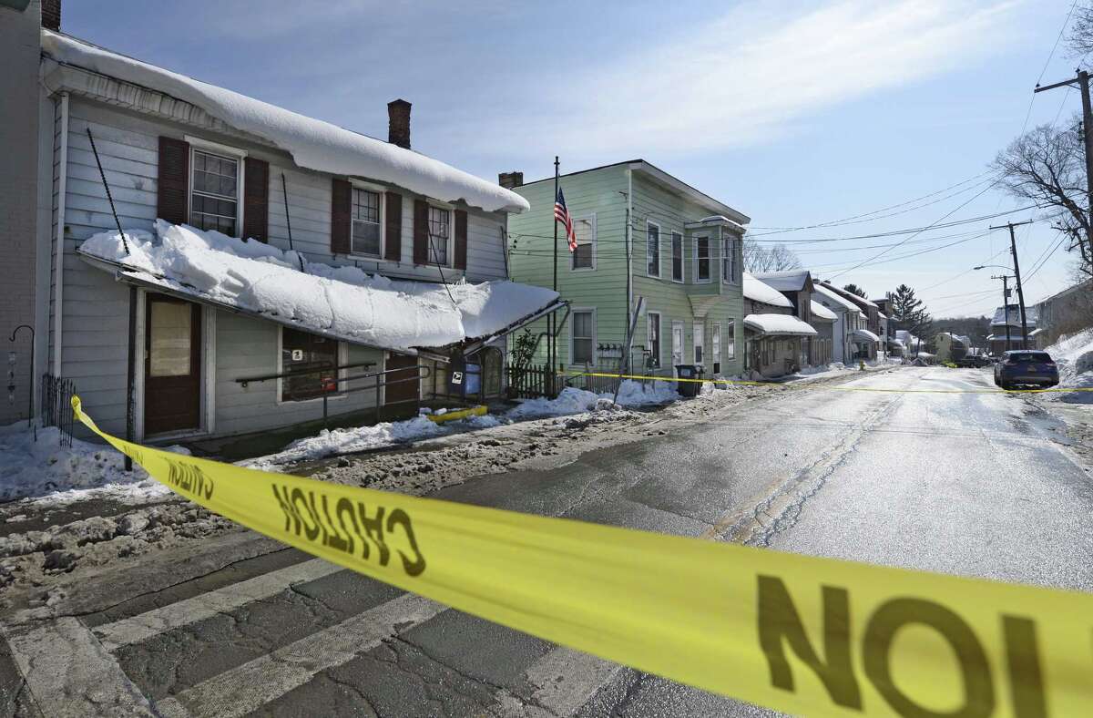 Snow partially collapsing post office canopy