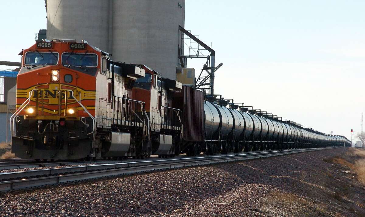 This Nov. 6, 2013, file photo, shows a BNSF Railway train hauling crude oil near Wolf Point, Mont. Railroads that haul volatile crude shipments have reached an agreement with U.S. transportation officials to adopt wide-ranging voluntary safety measures after a string of explosive and deadly accidents. (AP Photo/Matthew Brown, File)