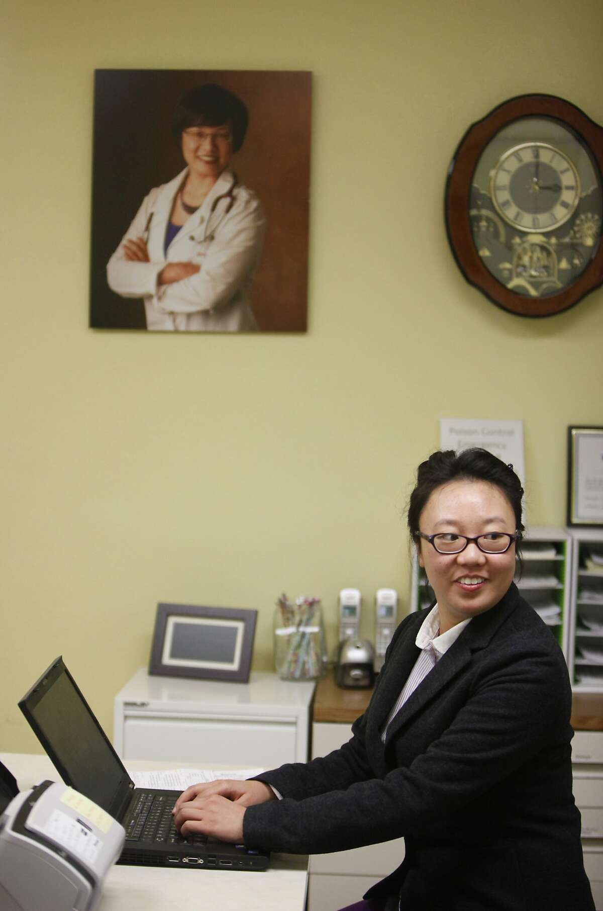 City College of San Francisco student Wendy Liu works on a computer at Sound Pediatrics where she works as a administrative assistant at her mother's practice on Tuesday, February 18, 2014 in Daly City, Calif.