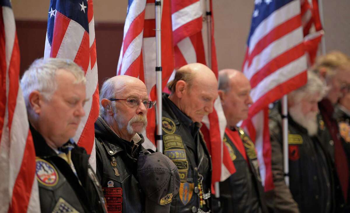 Members of the Patriot Guard bow their heads during the invocation Friday morning, Feb. 20, 2014, during the opening ceremony of a service which honored veterans of the WWII Pacific Theatre at the Zaloga Post in Albany, N.Y. (Skip Dickstein / Times Union)