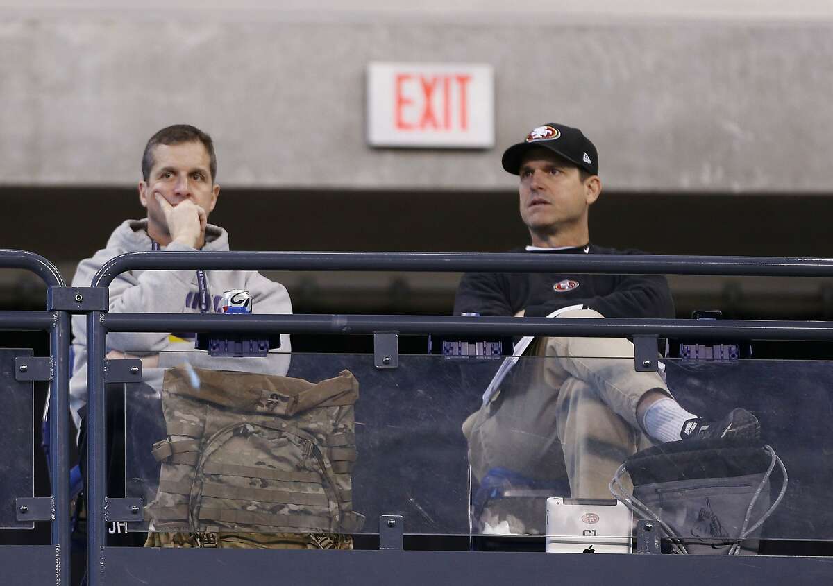 Feb 22, 2014; Indianapolis, IN, USA; Baltimore Ravens coach John Harbaugh on left and San Francisco 49ers coach Jim Harbaugh on right watch the players work out during the 2014 NFL Combine at Lucas Oil Stadium. Mandatory Credit: Brian Spurlock-USA TODAY Sports