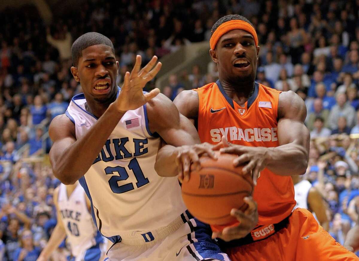 DURHAM, NC - FEBRUARY 22: Amile Jefferson #21 of the Duke Blue Devils battle for the ball with C.J. Fair #5 of the Syracuse Orange during their game at Cameron Indoor Stadium on February 22, 2014 in Durham, North Carolina. (Photo by Grant Halverson/Getty Images)