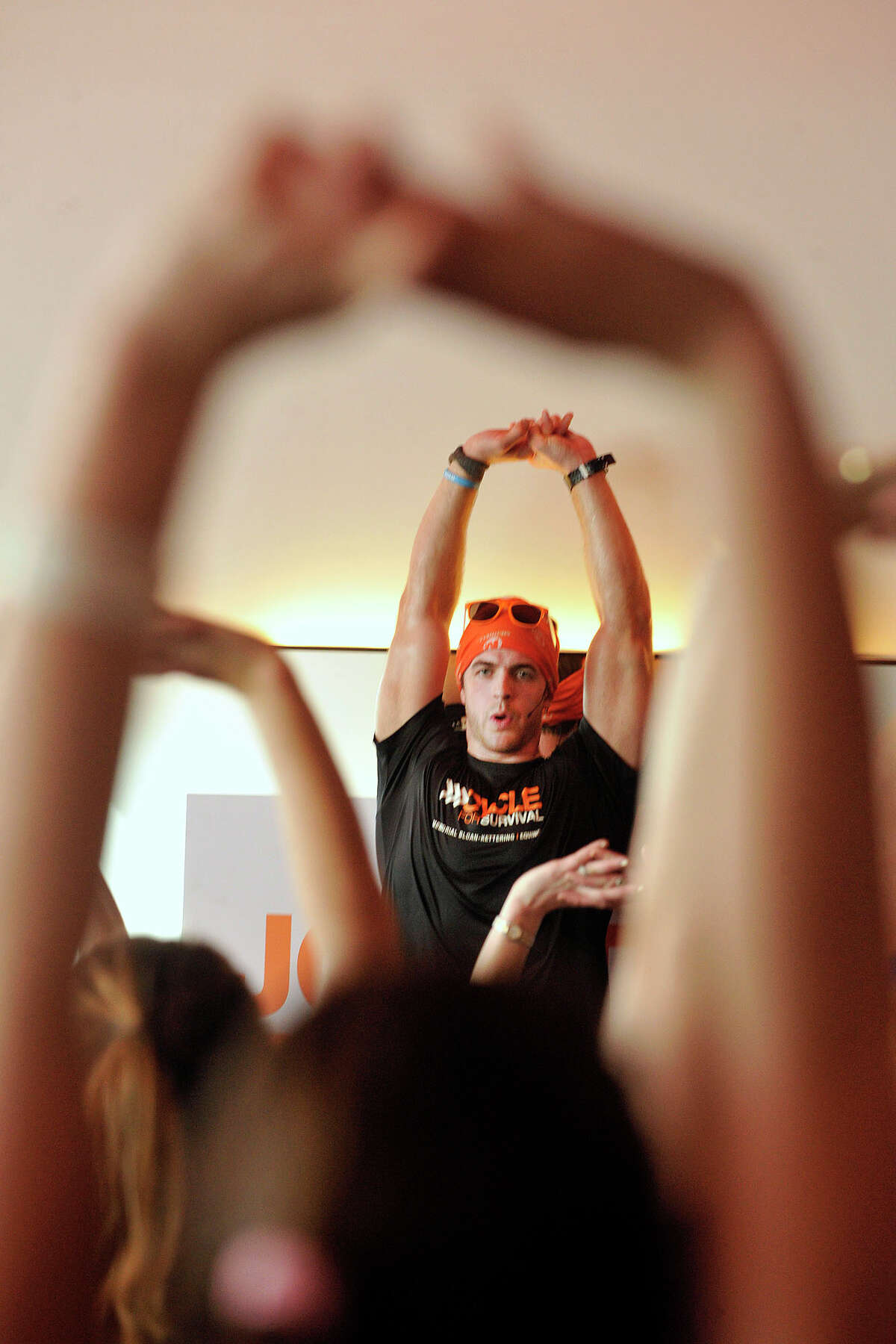Webb Travis leads a group of cyclists in stretching exercises during the Cycle for Survival event benefiting Memorial Sloan Kettering Cancer Center at Equinox fitness center in Greenwich, Conn., on Sunday, Feb. 23, 2014. Nationally, Cycle for Survival has raised over $47 million for rare cancer research.