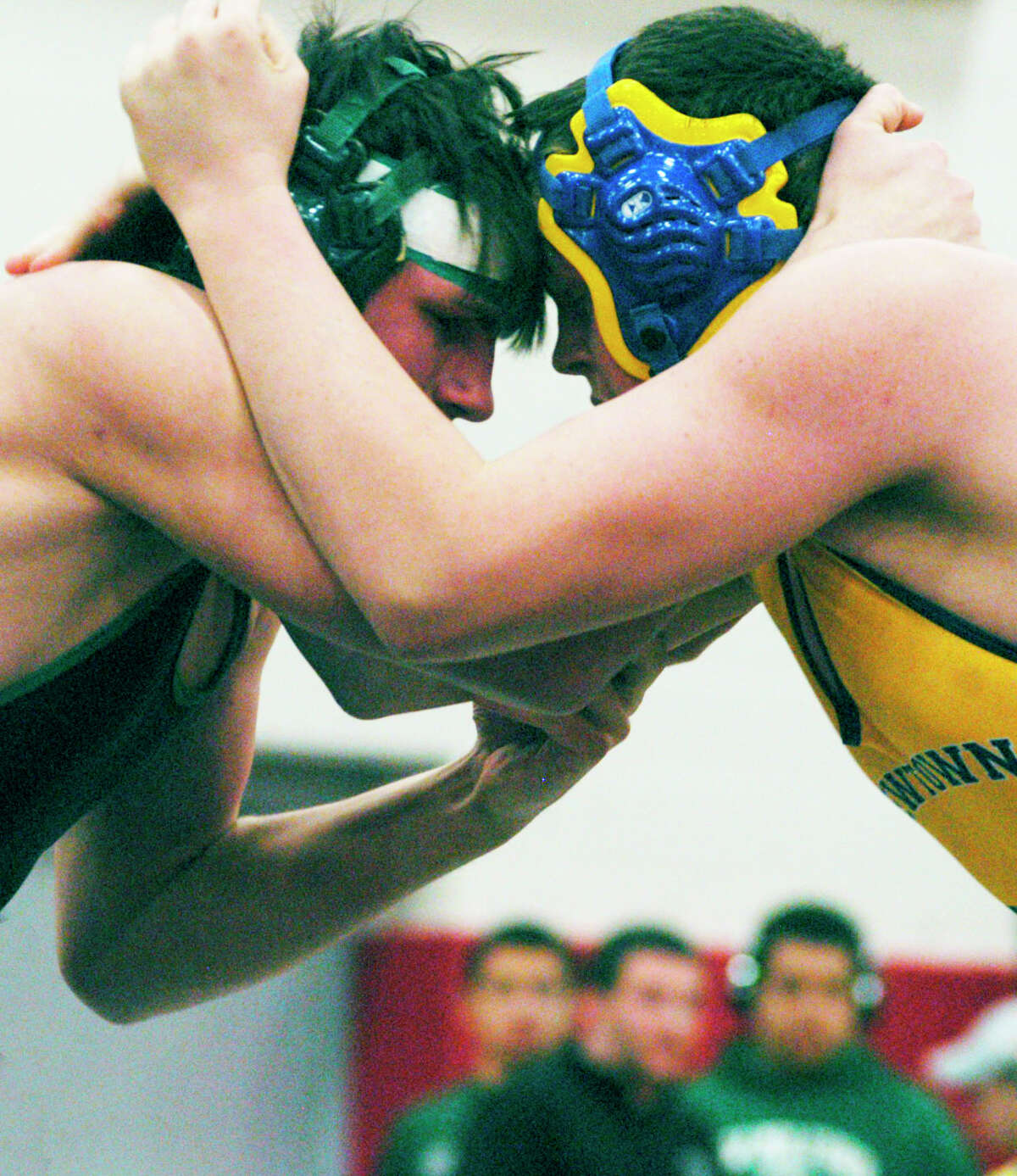 Tom McIlveen of the Green Wave duels 220-pound rival Ryan Wagner of Newtown for New Milford High School wrestling in the pivotal match during the South-West Conference championship tournament at Pomperaug High School in Southbury, Feb.16, 2014.
