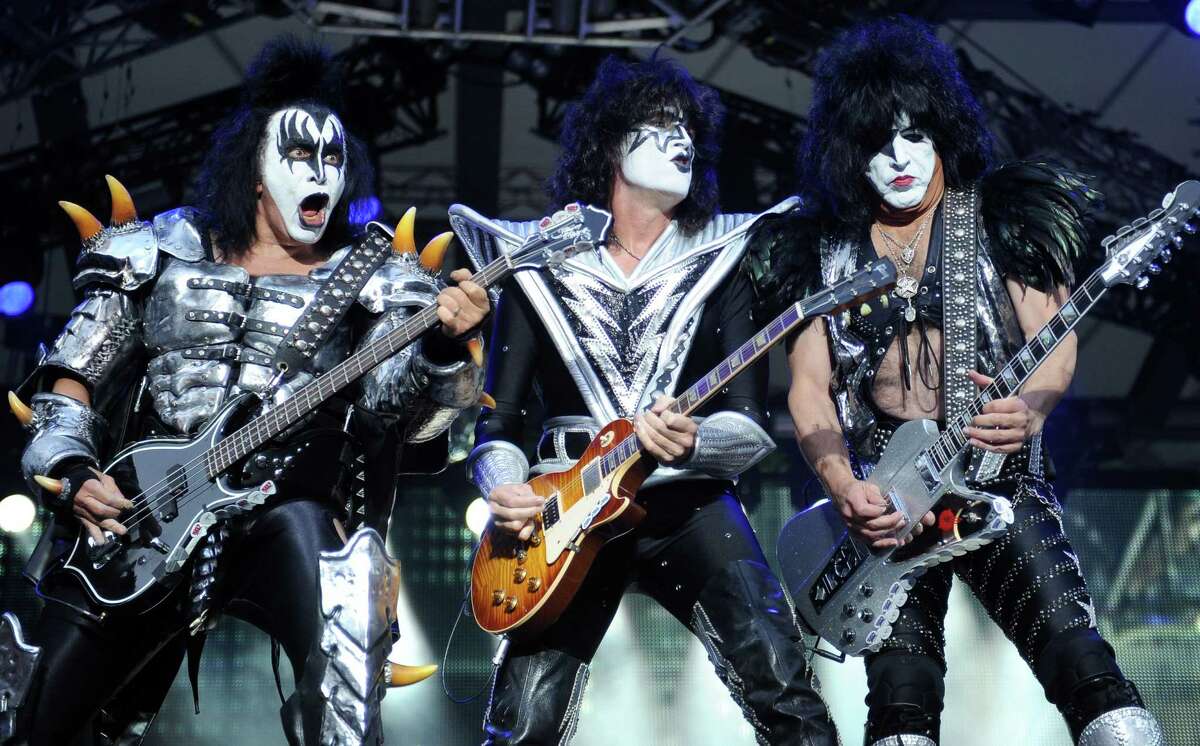 FILE - In this Thursday June 13, 2013, file photo, from left: bassist Gene Simmins , guitarist Tommy Thayer and singer Paul Stanley of the US band Kiss perform on stage in Berlin, Germany. Kiss announced Sunday, Feb. 23, 2014 that the band will not perform when they are inducted into the Rock and Roll Hall of Fame in Cleveland in April. The 40-year-old band is unable to agree on which lineup should perform during the April 10 ceremony in New York City. (AP Photo/dpa,Britta Pedersen, File) ORG XMIT: NY114