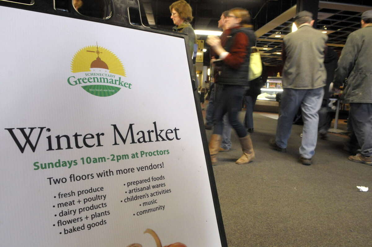 Shoppers make their way between vendors at the Schenectady Greenmarket inside Proctor's Theatre in Schenectady. (Paul Buckowski / Times Union archive)
