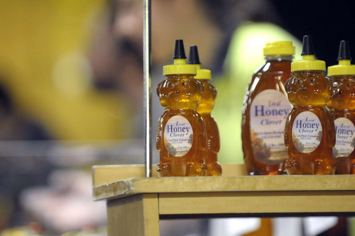 Locally produced honey is for sale at the Schenectady Greenmarket inside Proctor's Theatre in Schenectady. (Paul Buckowski / Times Union archive)