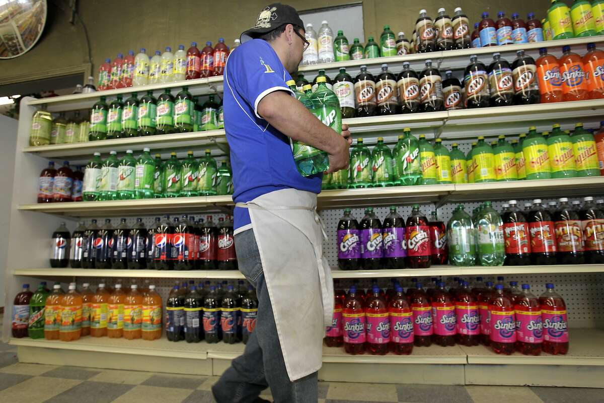 Juan Cerritos, who works at Val Mar Market in Richmond, stocks the shelves of liter bottles of soda. He is also a soda drinker and does not plan to vote for the new tax. The Richmond City Council has approved a measure for the November ballot which would ask voters to approve a tax on soda and sugary drinks, the first such tax in the nation.