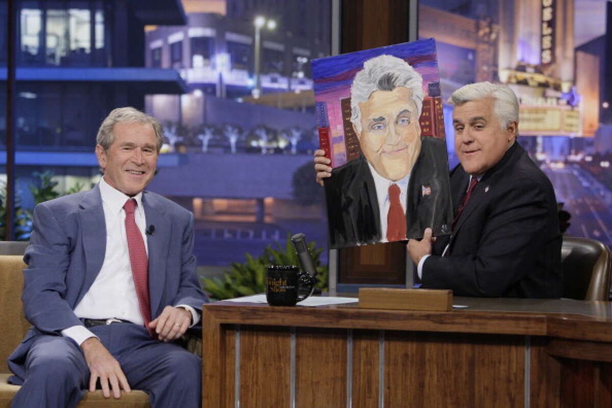George W. Bush presented a portrait he painted of Jay Leno to the Tonight Show host Nov. 19, 2013.