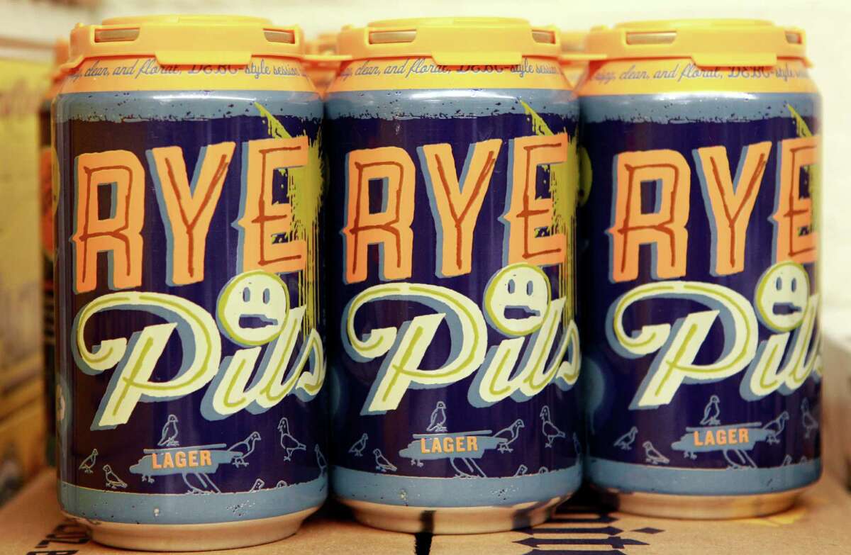 Cans of Deep Ellum Brewing Company's Rye Pils is shown Friday, Feb. 21, 2014, in Houston. Joey Williams is the beer department manager at Spec's. ( Melissa Phillip / Houston Chronicle )