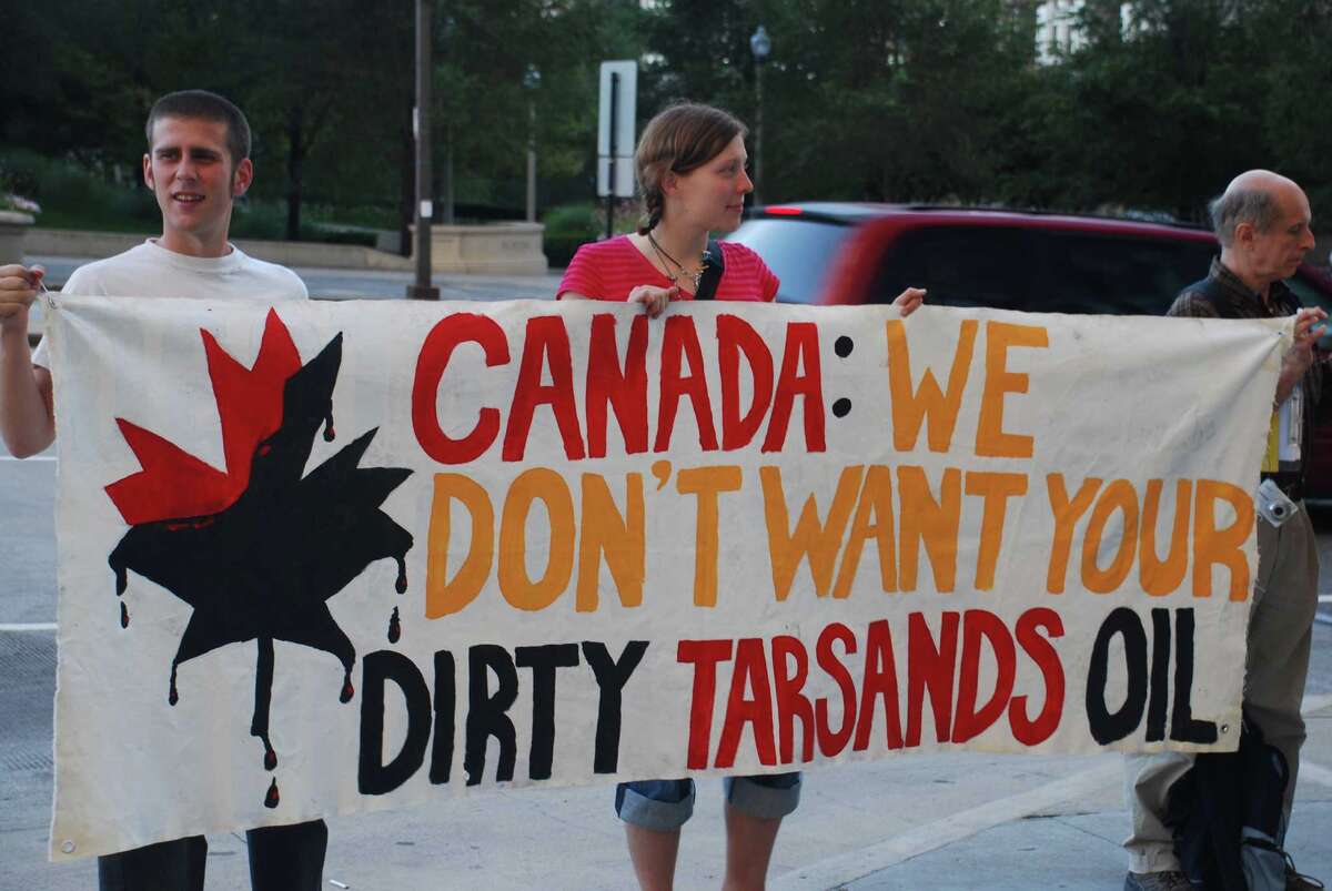 Environmental leaders are opposed to the proposed Keystone XL pipeline which, if approved and built, would transport tar sands fuels through the Midwestern U.S. to refineries in the Gulf of Mexico. Above, a Rainforest Action Network anti tar sands pipeline protest in front of the Canadian Consulate in Chicago. Photo courtesy of the Rainforest Action Network.