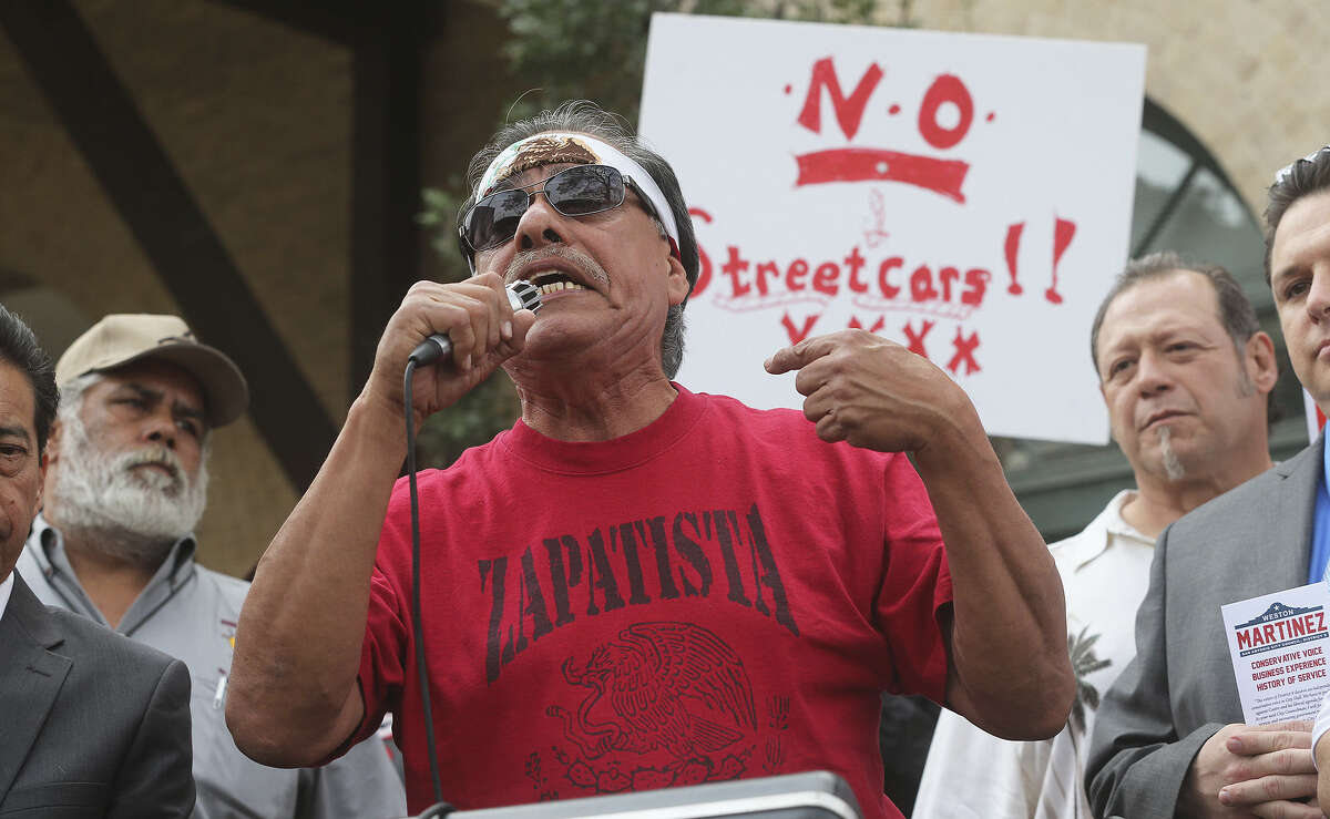 Henry Rodriguez protests the streetcar project outside the West Side Multimodal Transit Center as VIA Metropolitan Transit's board meets inside.