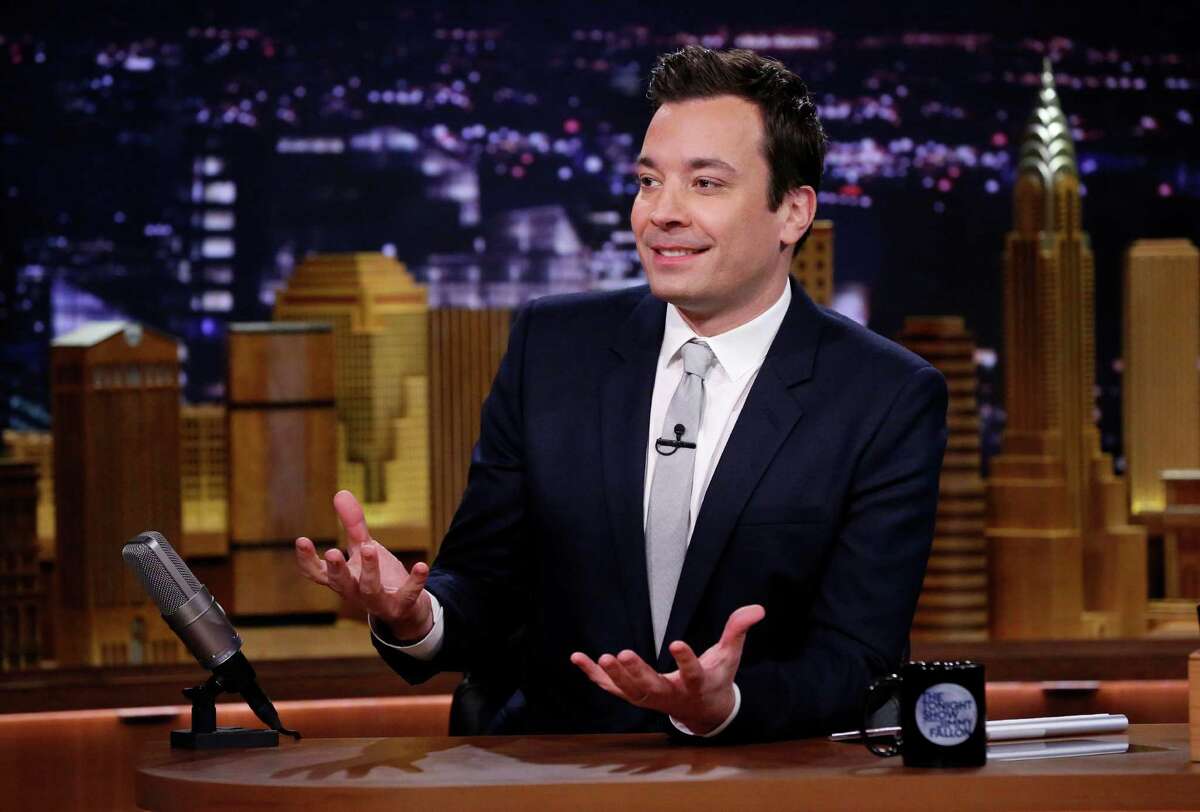 FILE- In this Feb. 18, 2014 file photo released by NBC, host Jimmy Fallon is seated at his desk during "The Tonight Show Starring Jimmy Fallon," in New York. Fallon, a New Yorker who wanted the excitement of the nationÂ?’s largest city to permeate his show, brought Â?“The Tonight ShowÂ?” back to New York after 40 years on the West Coast. Producing the show in New York also nets NBC a 30 percent tax credit that can save the network more than $20 million a year. (AP Photo/NBC, Lloyd Bishop, File)