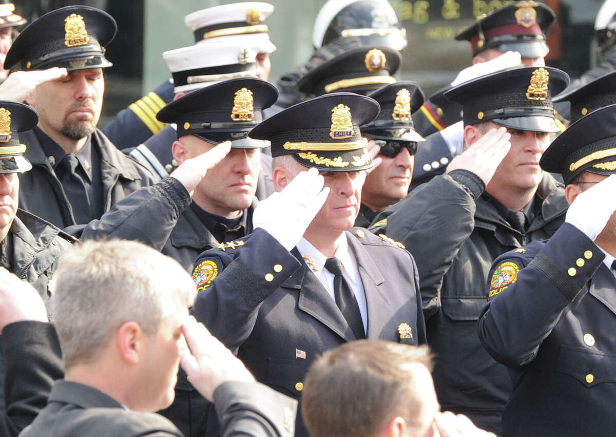 Greenwich Police Chief James Heavey, center, and Greenwich Police Officers salute during the funeral for Greenwich Police Sgt. Roger Petrone at St. Mary Church, Greenwich, Wednesday morning, Feb. 26, 2014. Petrone died Thursday at age 44 after a seven year battle with amyotrophic lateral sclerosis, also known as Lou Gehrig's disease.