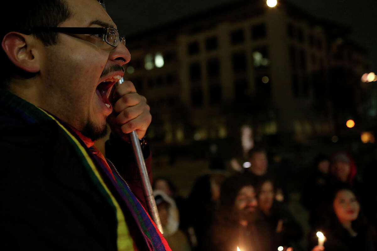 Supporters of marriage equality including Julius Lorenzi, left, chant during the "Light The Path to Marriage Equality" candlelight vigil outside the Bexar County Courthouse in San Antonio on Tuesday, Feb. 11, 2014.